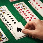 Digital Spider Solitaire card game interface on clean green felt background